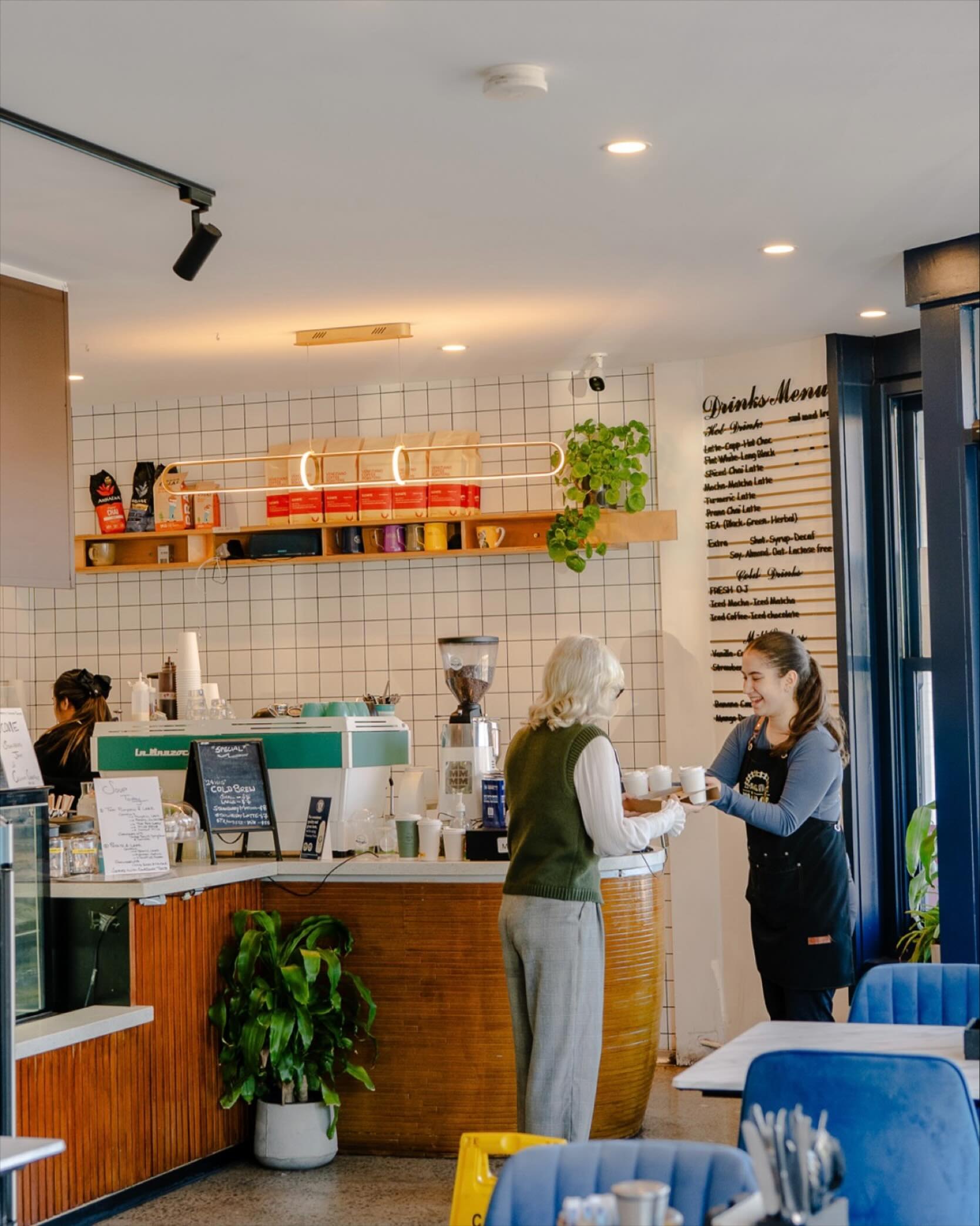 Staff and customers at the counter of Station Mingle Cafe